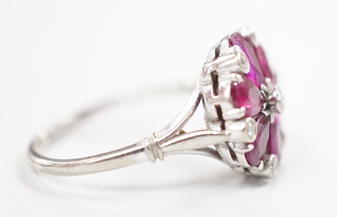 An 18ct & plat, pear cut ruby and diamond chip cluster set ring, size N/O, gross weight 4.8 grams.